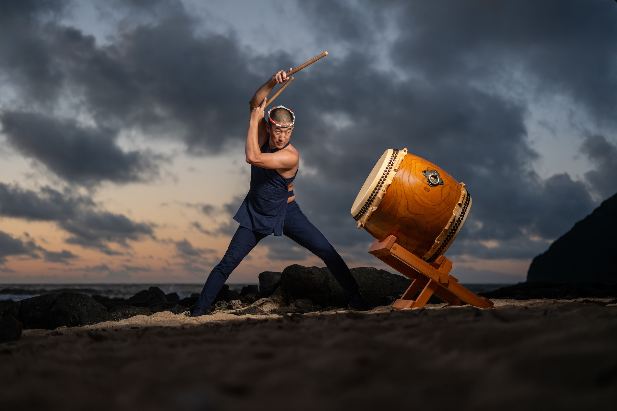 Michael Gonhata preparing an overhead taiko strike on the shoreline